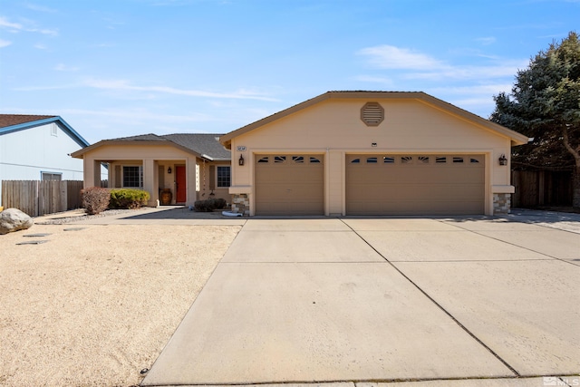 ranch-style house with concrete driveway, an attached garage, fence, and stone siding