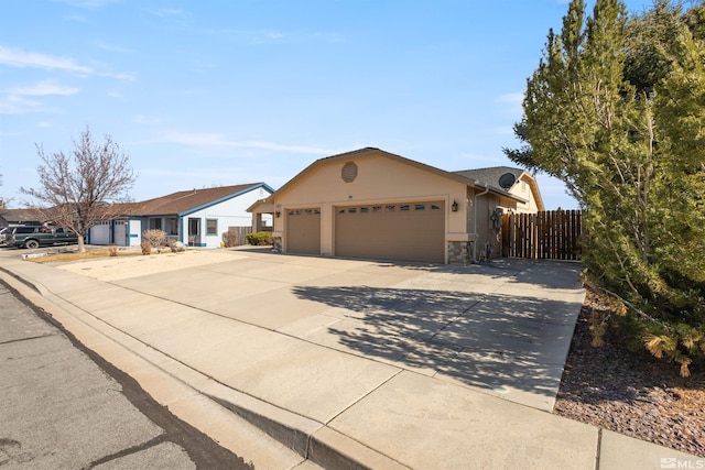 single story home featuring stucco siding, driveway, stone siding, fence, and a garage