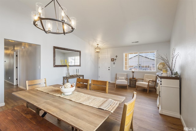 dining room with plenty of natural light, wood finished floors, visible vents, and a chandelier