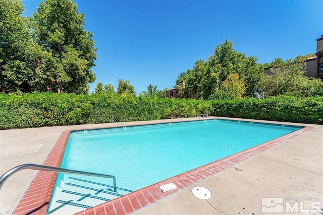 view of swimming pool featuring a fenced in pool