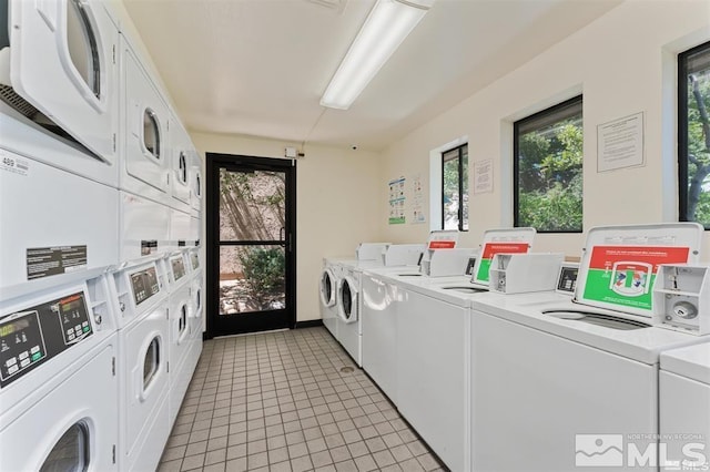 shared laundry area with stacked washer / dryer, light tile patterned flooring, and independent washer and dryer