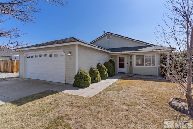 ranch-style home featuring a front yard, concrete driveway, a garage, and fence