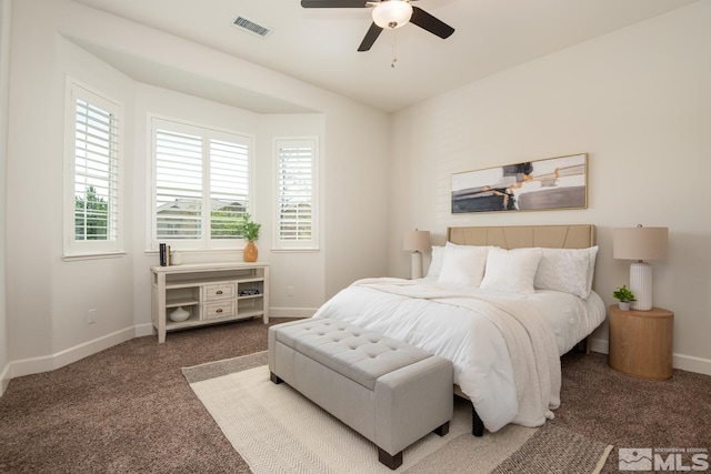 carpeted bedroom featuring visible vents, a ceiling fan, and baseboards