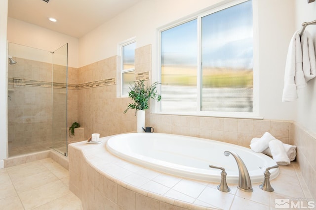 full bathroom with tile patterned floors, a shower stall, and a garden tub