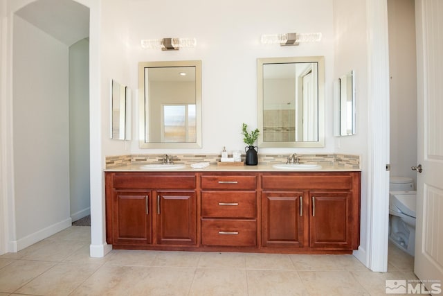 full bath with tile patterned flooring, backsplash, toilet, and a sink