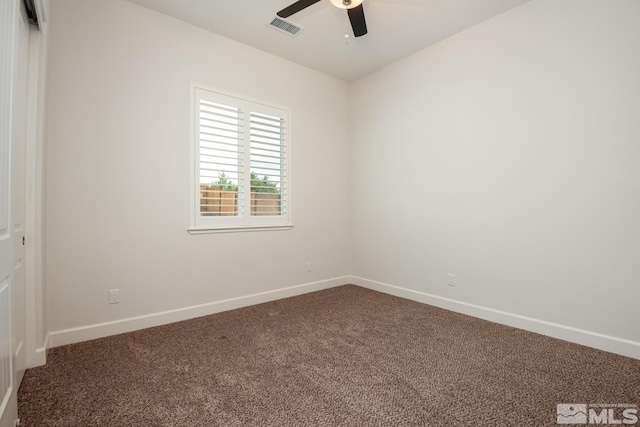 unfurnished room with visible vents, carpet floors, baseboards, and a ceiling fan