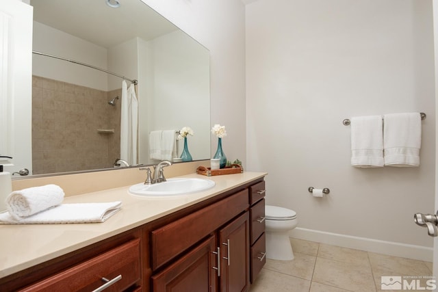 full bath with tile patterned floors, toilet, vanity, and baseboards