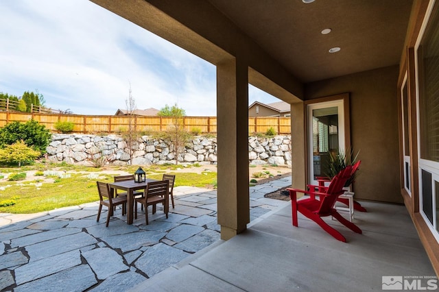 view of patio featuring outdoor dining area and fence private yard