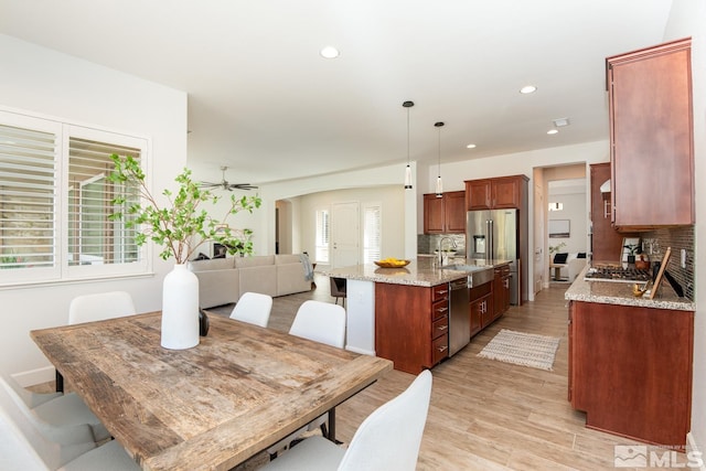 dining space featuring recessed lighting, a ceiling fan, and light wood finished floors