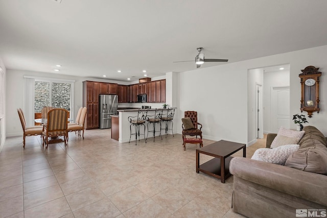 living area featuring a ceiling fan, light tile patterned floors, recessed lighting, and baseboards