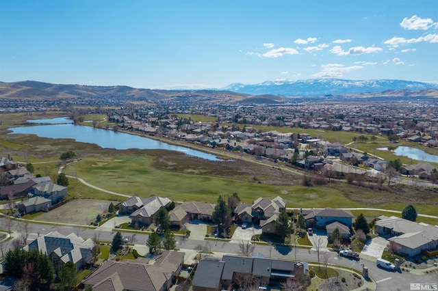 birds eye view of property featuring a residential view and a water and mountain view