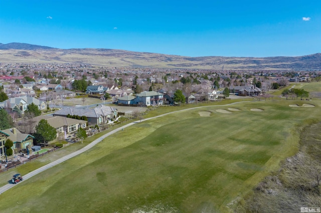 drone / aerial view featuring a residential view, a mountain view, and golf course view