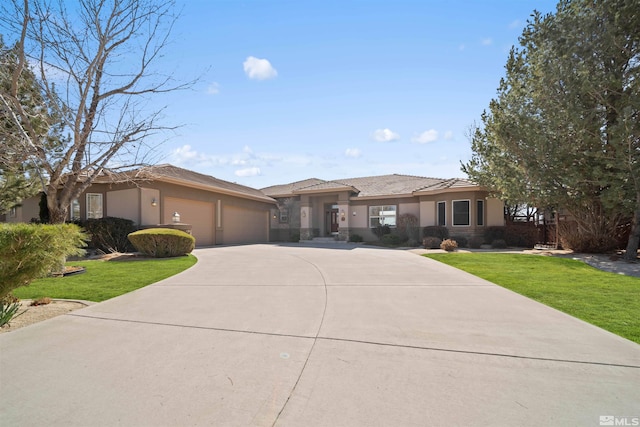 view of front of house featuring stucco siding, driveway, a front yard, and an attached garage