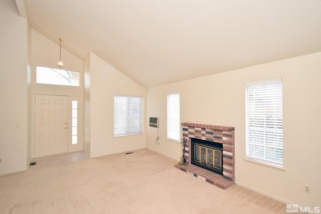 living area featuring carpet floors, a healthy amount of sunlight, and a fireplace