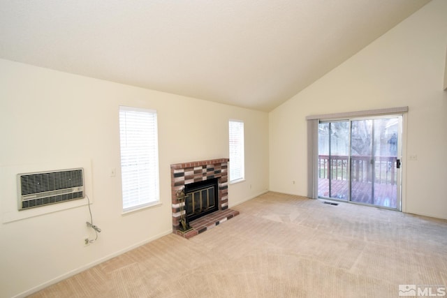 unfurnished living room featuring lofted ceiling, an AC wall unit, a fireplace, and light carpet