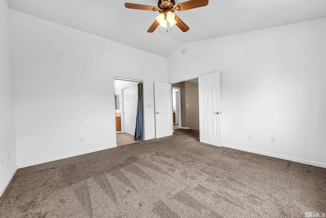 unfurnished bedroom featuring carpet flooring, ensuite bathroom, baseboards, and vaulted ceiling