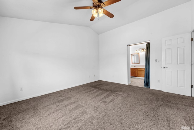 spare room featuring vaulted ceiling, baseboards, ceiling fan, and carpet floors