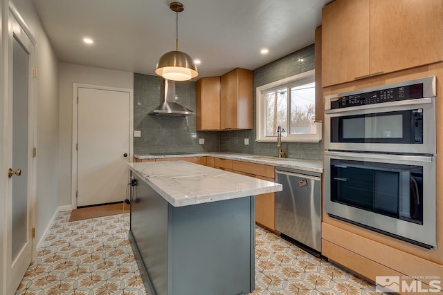 kitchen with a sink, a kitchen island, stainless steel appliances, wall chimney exhaust hood, and decorative backsplash