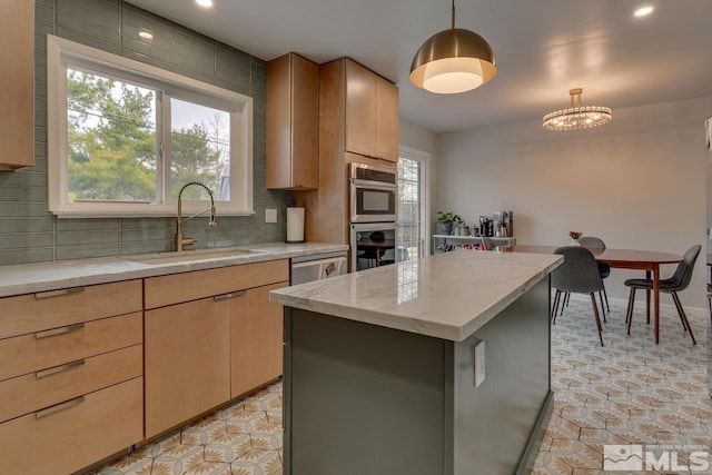 kitchen with backsplash, light brown cabinets, a kitchen island, pendant lighting, and a sink