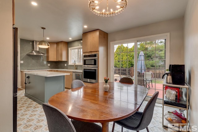 dining room with an inviting chandelier, recessed lighting, light floors, and a wealth of natural light