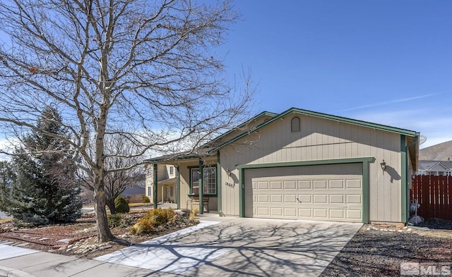 ranch-style house with concrete driveway, fence, and a garage