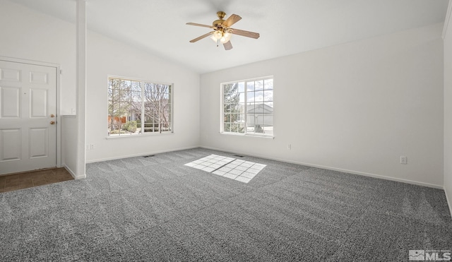 empty room featuring baseboards, carpet floors, ceiling fan, and vaulted ceiling