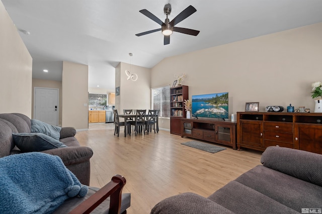 living area featuring light wood-type flooring, lofted ceiling, baseboards, and ceiling fan