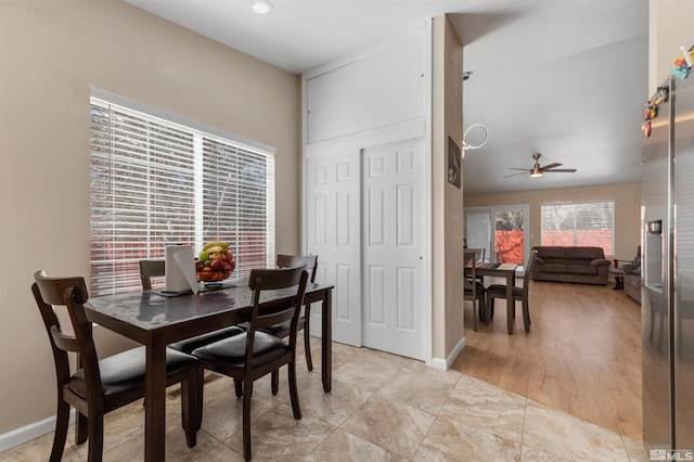 dining area with ceiling fan and baseboards