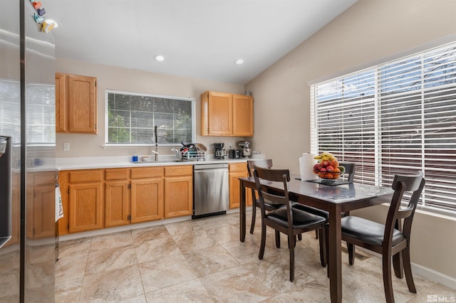 kitchen featuring recessed lighting, a sink, vaulted ceiling, light countertops, and dishwasher