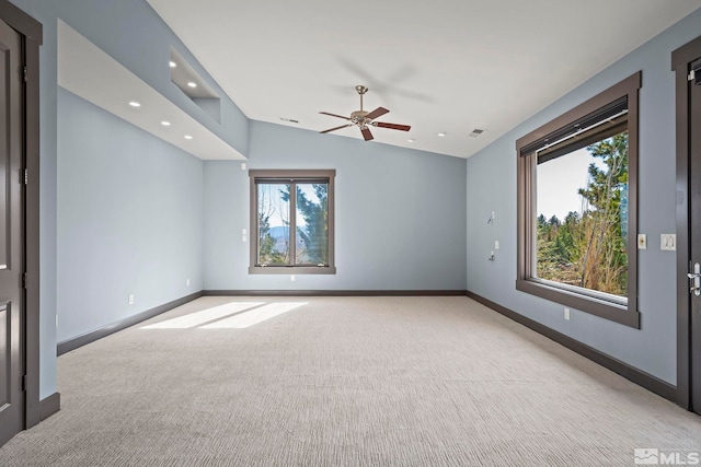 unfurnished room with visible vents, lofted ceiling, recessed lighting, baseboards, and light colored carpet