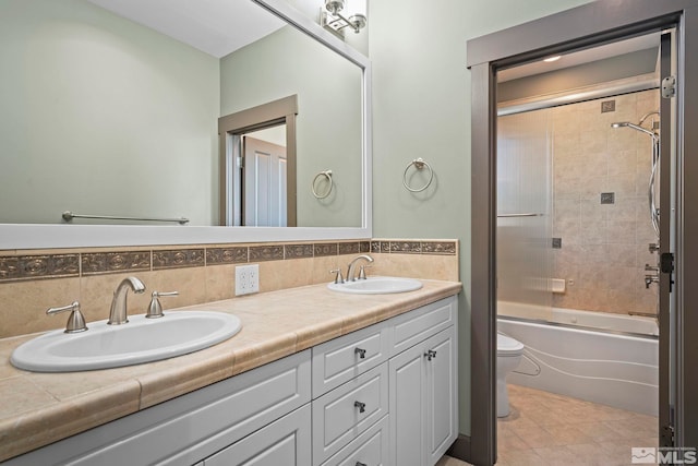 full bath with a sink, backsplash, and toilet