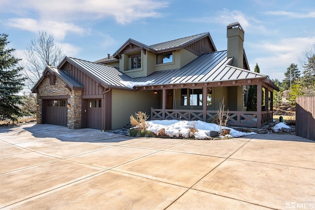 view of front facade with a standing seam roof, covered porch, and metal roof