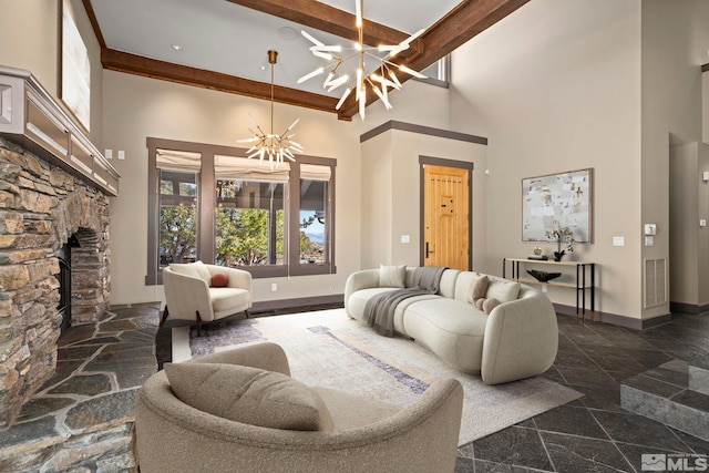 living room with visible vents, baseboards, an inviting chandelier, a towering ceiling, and granite finish floor