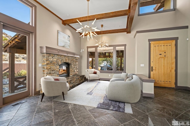 living room featuring visible vents, baseboards, beam ceiling, a stone fireplace, and a towering ceiling