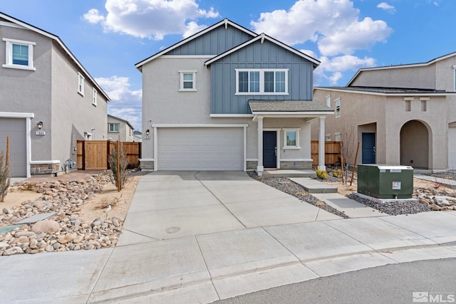 view of front of property featuring an attached garage, concrete driveway, board and batten siding, and fence