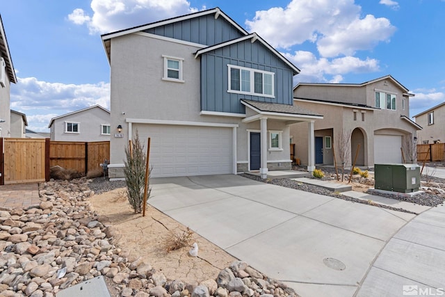 view of front of house featuring driveway, board and batten siding, an attached garage, and fence