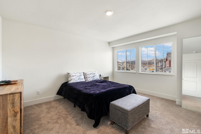 carpeted bedroom featuring baseboards