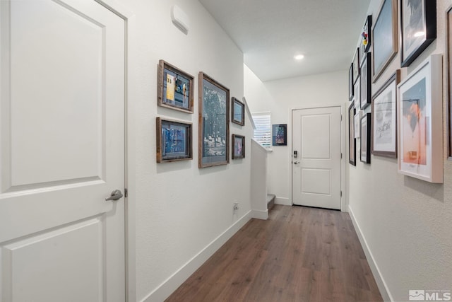 hall featuring wood finished floors and baseboards