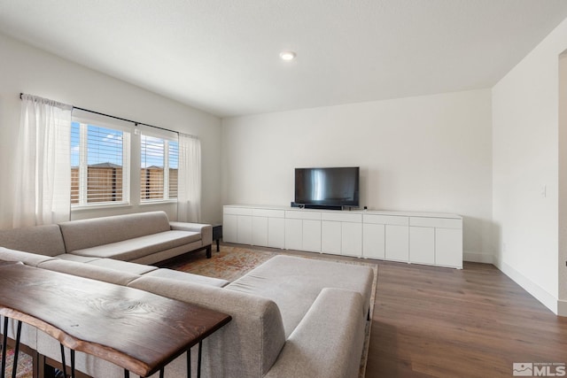 living area with wood finished floors and baseboards