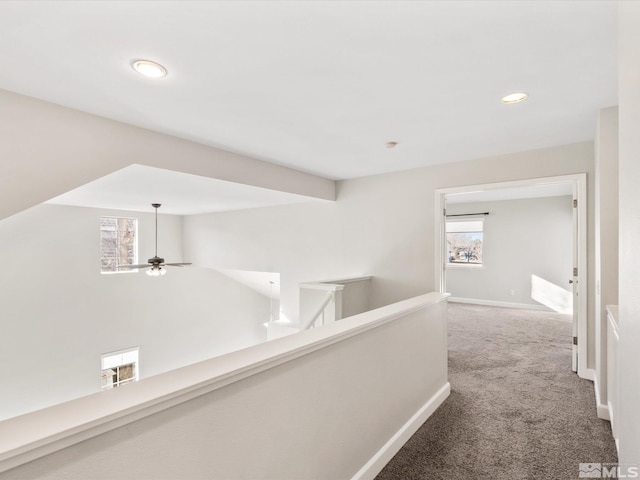 corridor featuring recessed lighting, an upstairs landing, baseboards, and carpet floors