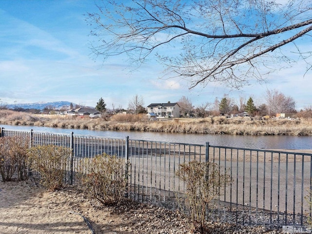 view of yard with a water view and fence