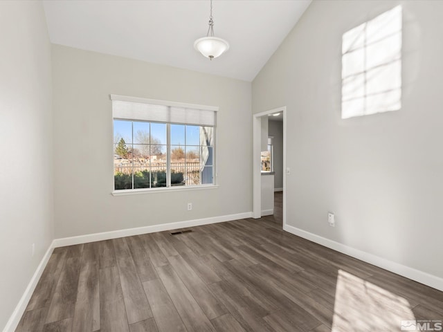 unfurnished room with visible vents, baseboards, and dark wood-style flooring