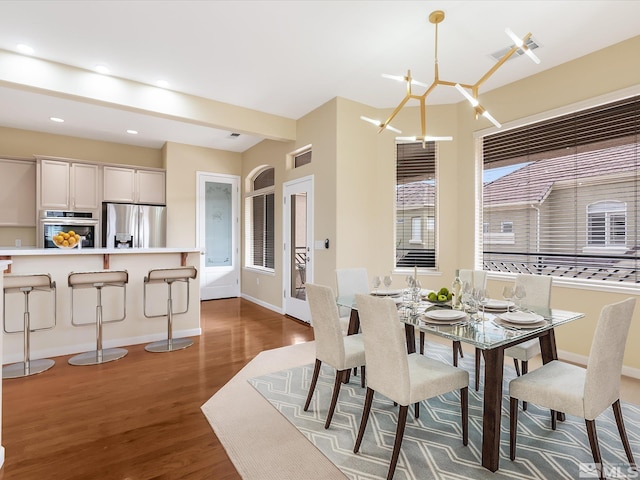 dining area with recessed lighting, an inviting chandelier, dark wood-type flooring, and baseboards