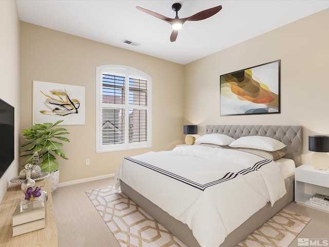 bedroom featuring visible vents, a ceiling fan, baseboards, and carpet floors