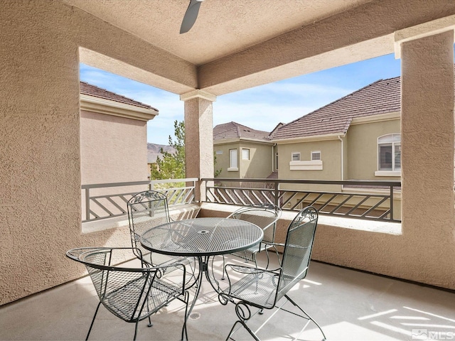 balcony with outdoor dining space and a ceiling fan