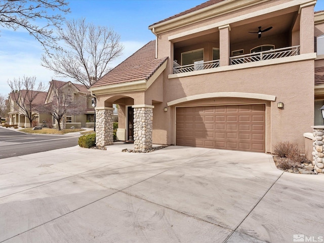 view of front of house featuring a balcony, stucco siding, driveway, and a garage