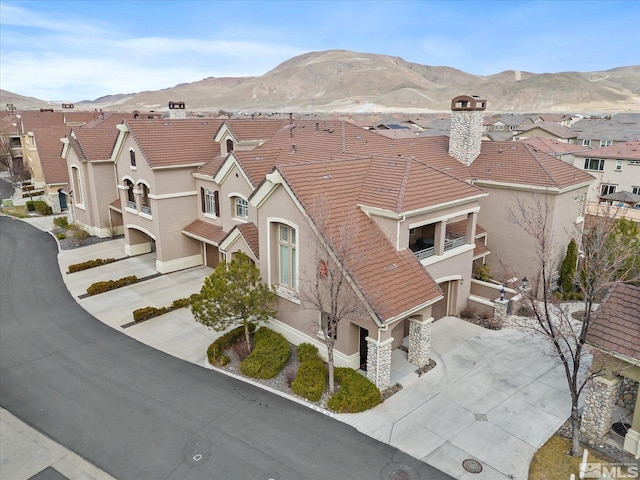 birds eye view of property featuring a mountain view and a residential view