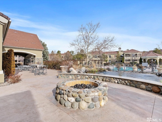 view of patio / terrace featuring an outdoor fire pit and fence