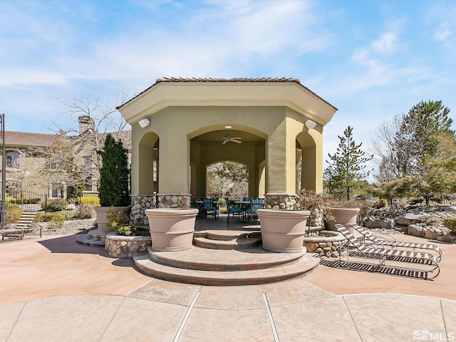 view of patio / terrace featuring a ceiling fan and fence