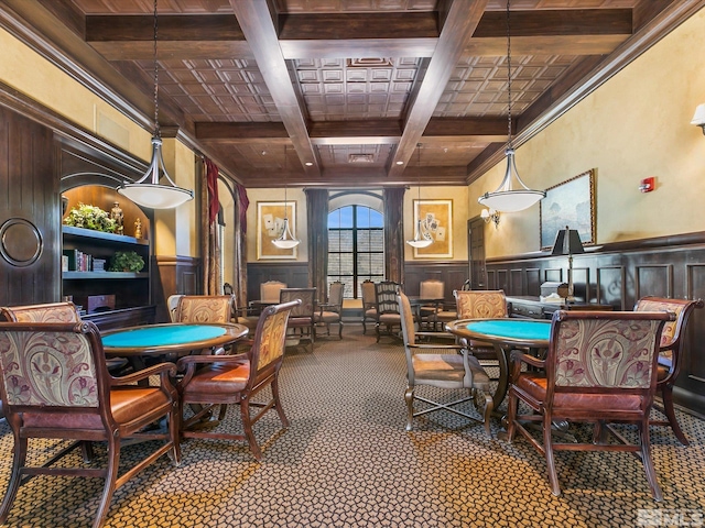 carpeted dining room with beamed ceiling, coffered ceiling, and wainscoting